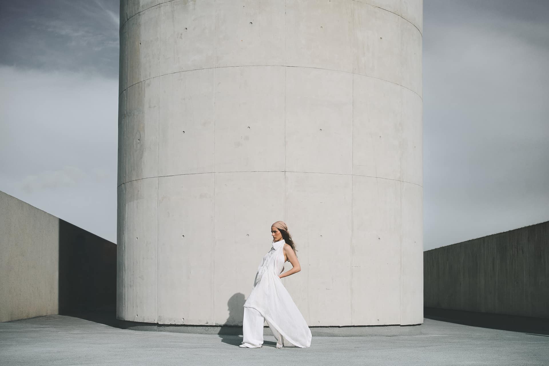 Modelo vestida de blanco entre torres de hormigón
